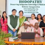 Hodopathy website inauguration in Giridih on 8 October 2026, with Rajeev Singh, traditional Adivasi knowledge holders, community members and medicinal plants displayed during the conservation event.